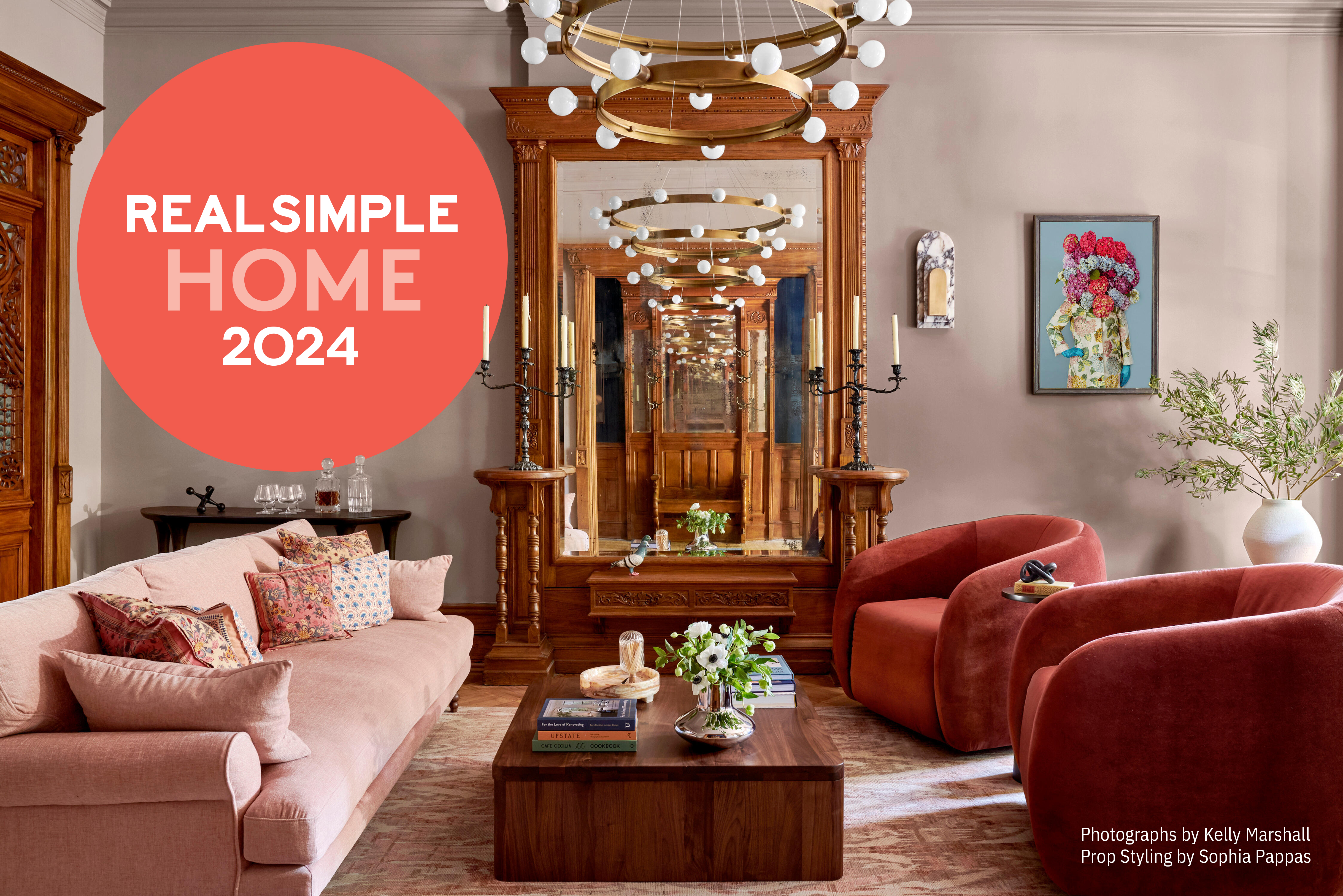 White walls frame floor-to-ceiling windows overlooking NYC. Neutral furniture and accessories with tall room divider.