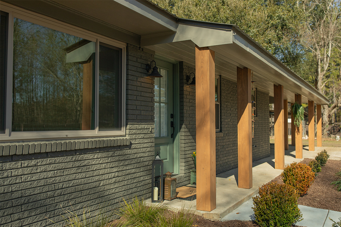 View of exterior home with wood acents