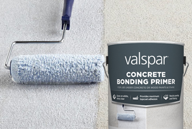 Roller applying light blue-gray Valspar Concrete Bonding primer to concrete surface. Can in foreground.